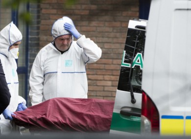 A member of the Garda Forensic Team looks on as the body of the three-year-old boy is placed in an ambulance on Tuesday.