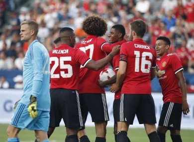 Man United celebrate Rashford's second goal.
