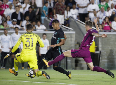 Ederson saves from Real Madrid midfielder Casemiro.