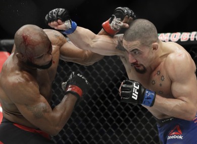 Yoel Romero, left, fights Robert Whittaker in a middleweight championship mixed martial arts bout at UFC 213.