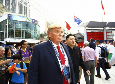 Men in masks of Donald Trump and Kim Jong-Un