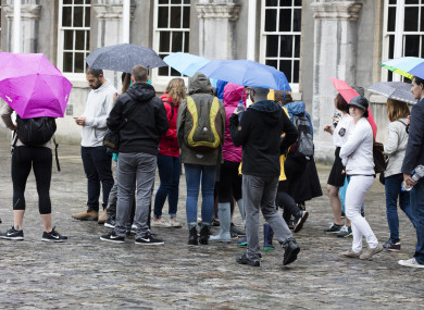 Tourists in the rain in Dublin Castle.