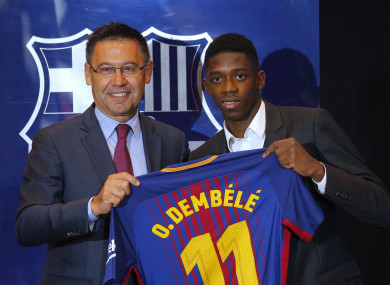 Barcelona's new signing player Ousmane Dembele, right, and FC Barcelona's president Josep Maria Bartomeu pose for the media during official presentation at the Camp Nou stadium.