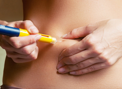 A woman injecting hormones for IVF.