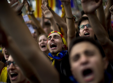 People gesture and shout slogans during a protest in Barcelona.