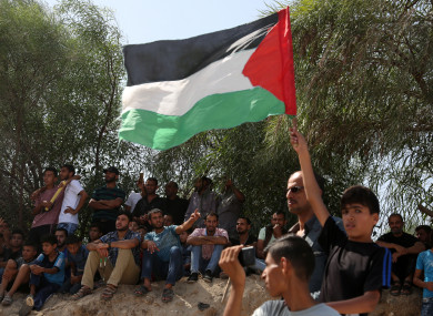 Palestinians celebrate as they wait for the arrival of Palestinian Prime Minister Rami Hamdallah and his government to take control of Gaza from the Islamist Hamas group.