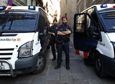 Catalan police officers stand guard next to the Palau Generalitat in Barcelona, Spain,