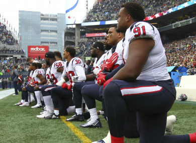 Rookie Carlos Watkins (91) and the rest of the Texans kneel during the anthem in Seattle.