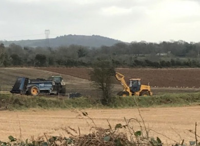Farm equipment spreading the treated sludge on the land in January.