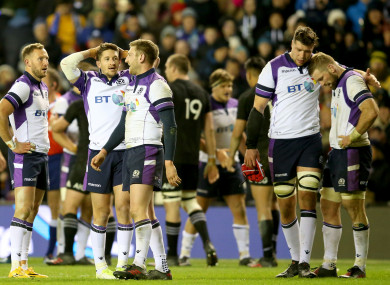 Scotland's players dejected after losing their match against the All Blacks.