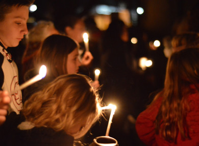 Aztec High School students and area residents gather for a candlelight vigil.