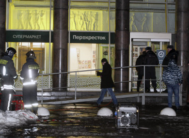 Police stand at the entrance of a supermarket, after an explosion in St Petersburg