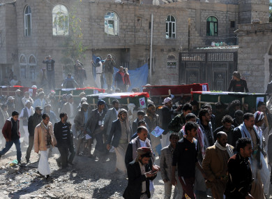 Yemeni people carry coffins of victims killed in airstrikes in Sanaa yesterday.