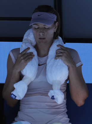 Russia's Maria Sharapova uses a cool towel during a break while playing Latvia's Anastasija Sevastova during their second round match at the Australian Open tennis championships in Melbourne.