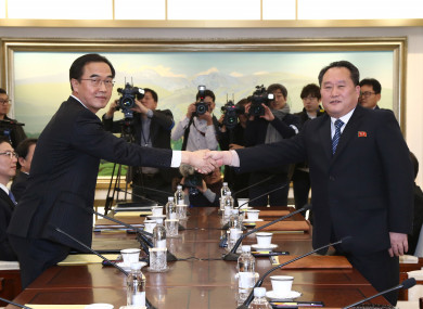 South Korean Unification Minister Cho Myoung-gyon, left, poses with head of North Korean delegation Ri Son Gwon.