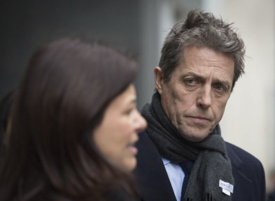 British actor Hugh Grant leaves the Rolls Building in London after settling his phone-hacking claims against Mirror Group Newspapers.