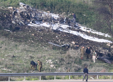 Israeli security personnel near the remains of one of its fighter planes.
