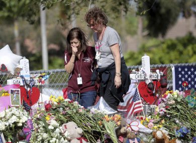 Margarita Lasalle, a bookeeper and Joellen Berman, a guidance data specialist look at the memorial after returning to the school.