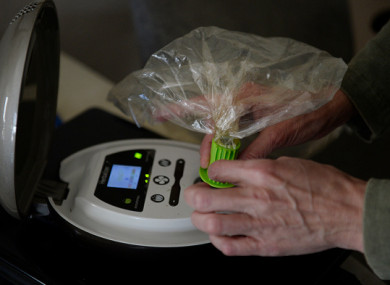 File photo: A different medical marijuana patient, uses a Herbalizer to fill a bag with cannabinoid vapor to manage chronic fibromyalgia in the US