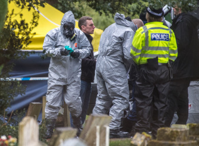 Officers in protective suits in London Road cemetery.