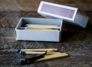The court heard the man appeared at an upstairs window in his house with a pint glass “filled to the brim” and a big box of matches.