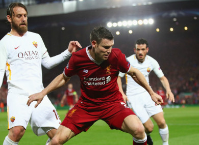 Daniele De Rossi (left) challenges James Milner.