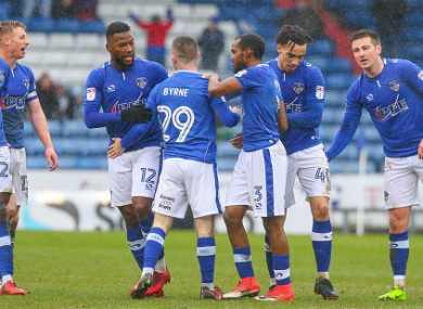 Byrne (centre) celebrates his goal with his Oldham team-mates.
