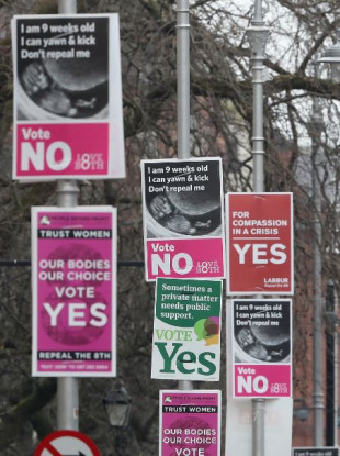 Posters in favour of and against repealing the Eighth Amendment outside Government Buildings in Dublin, ahead of the referendum on 25 May