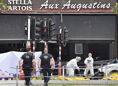 Forensic police investigate at the scene of a shooting in Liege, Belgium