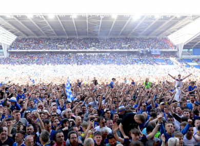 Cardiff City fans flood the pitch to celebrate their promotion to the Premier League.