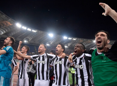 Juventus players celebrate with supporters in the away end at the Stadio Olimpico.