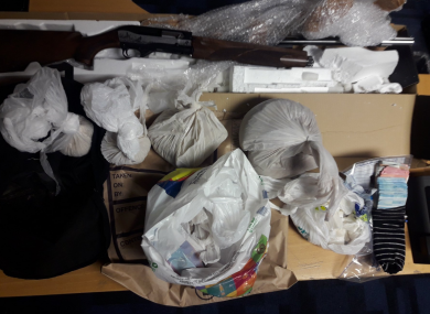 The shotgun and some of the drugs seized.
