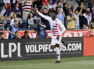Tim Weah celebrates a goal.