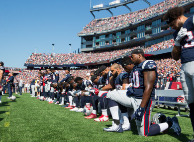 New England Patriots players take a knee before playing the Houston Texans last season.