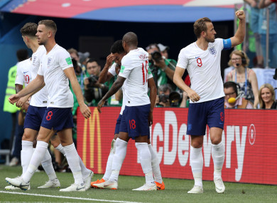 Kane (right) salutes fans.