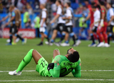 Saudi Arabia goalkeeper Mohammed Alowais lies on the ground after the final whistle.