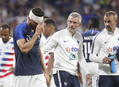 Giroud walks off after a clash of heads.