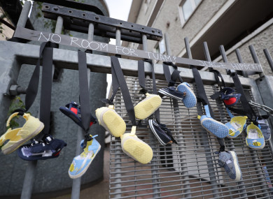 Pairs of baby shoes hang from the railings on Sean McDermott Street in Dublin in memory of the children who died at the mother and baby home in Tuam.