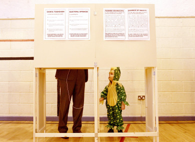 Daniel McGuire dressed up for his third birthday watches as his father Micheal casts his vote in Galway in October, 2011.
