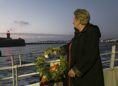 Mary McCarthy, whose husband’s grandfather Adam Smyth died in the sinking of the RMS Leinster, with a wreath as she leaves Dun Laoghaire.