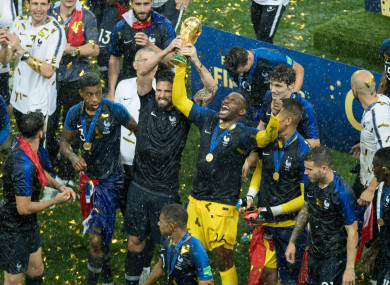 France players celebrate with the World Cup trophy.