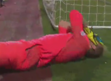 Hearts goalkeeper Zdenek Zlamal lies on the ground holding his face.