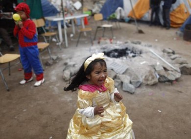 Lizet Gallardo, granddaughter of trapped miner Mario Gomez, plays at the San Jose mine near Copiapo, Chile on Sunday