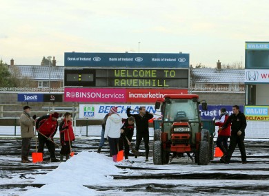 Fans and players brave the cold to help Ulster Rugby staff clear snow from the pitch at Ravenhill ahead of Saturday's Heineken Cup match against Bath.
