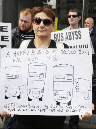 One of the protesters holds up a placard on O'Connell Street in Dublin today.