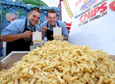 Catering Manager Gregg Smith (left) and Head of Catering James Gibbs smile, after breaking the current weight of 368.5 kg of the Guinness World Record for the biggest portion of chips ever served, at Adventure Island, Southend-on-Sea, Essex.