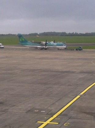 The Aer Arann aircraft, carrying Aer Lingus branding, is towed away at Shannon airport this afternoon.