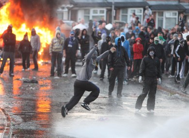 Nationalist youths hijack a car in Ardoyne in north Belfast, after officers cordoned off the area to allow through a loyalist parade.