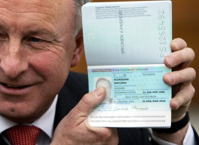 Former justice minister Dermot Ahern poses with a new 'e-passport'. Irish students travelling in the US have been found doctoring their passports, trying to pass themselves off as being over 21.
