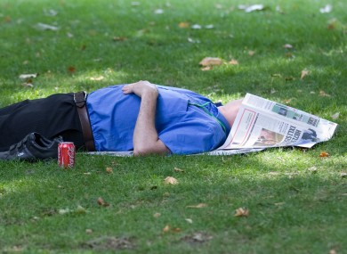 They're getting the sun in London! An office worker enjoys his break in St. James Park